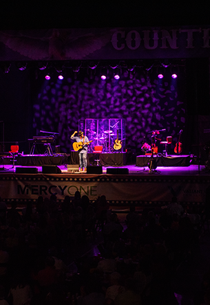 Country artist on stage with purple lights